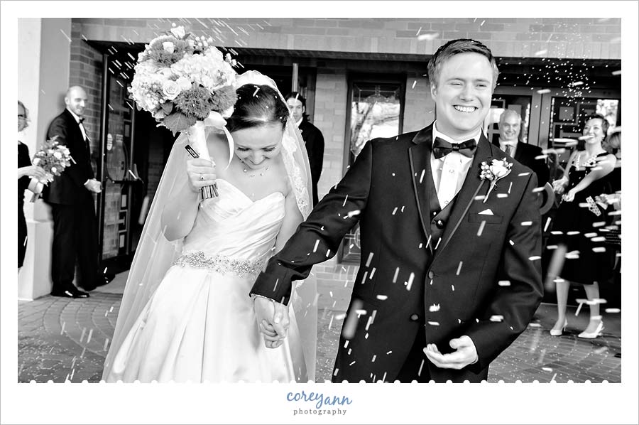 rice being tossed during exit from wedding ceremony