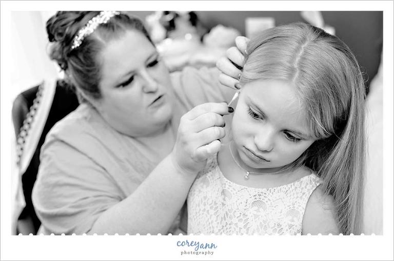 bride helping niece with earrings