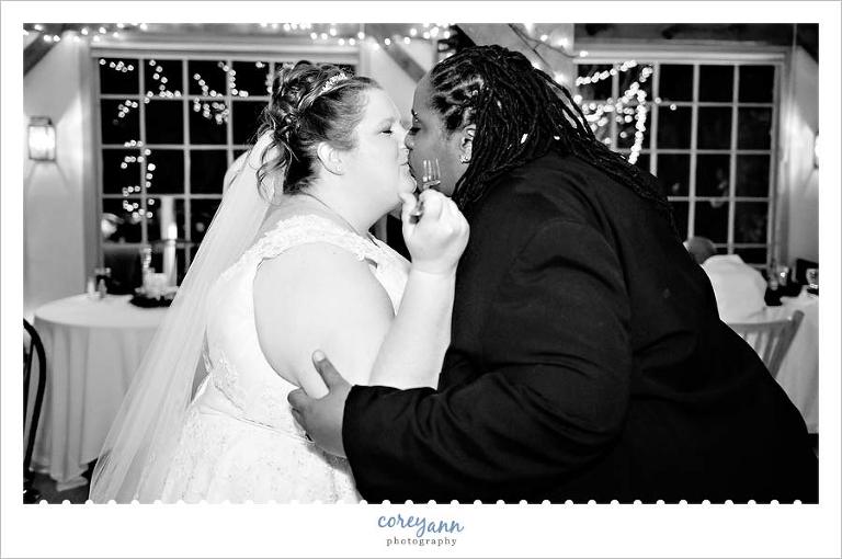 kissing after cake cutting at bittersweet farm wedding reception