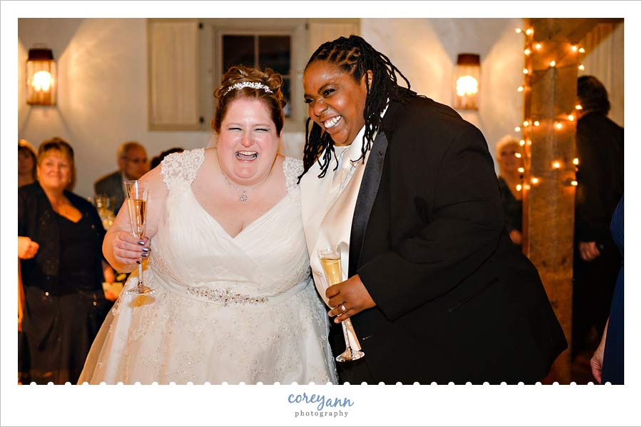brides laughing during toast at wedding