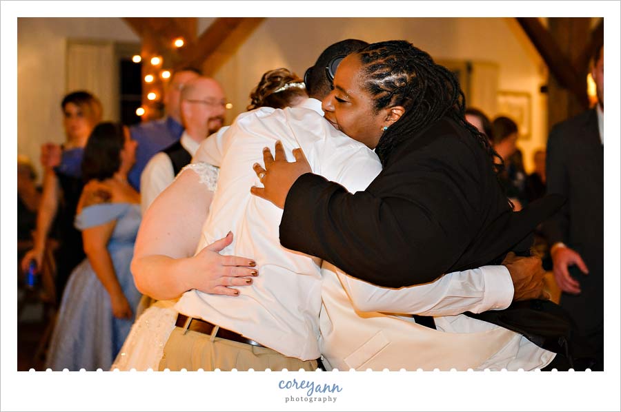 hugs after toast at wedding reception at bittersweet farms