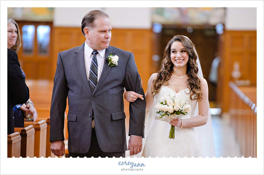 Bride smiling when she sees groom for the first time 