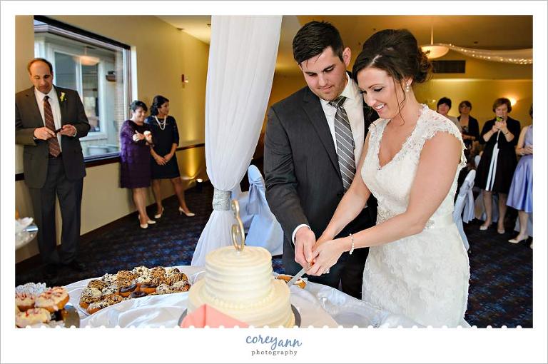 Bride and Groom cutting the cake at wedding reception in Akron Ohio