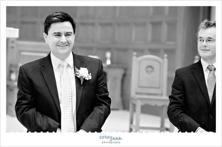 Groom smiling when he sees the bride for the first time