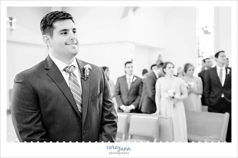 Groom smiling when he sees his bride for the first time in Ohio