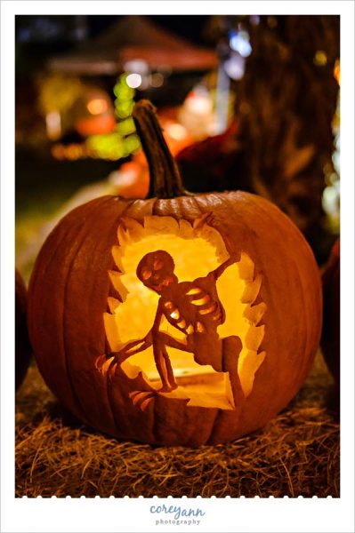 Skeleton escaping from carved pumpkin