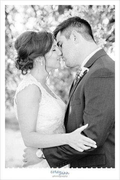 Bride and groom going in for a kiss in black and white
