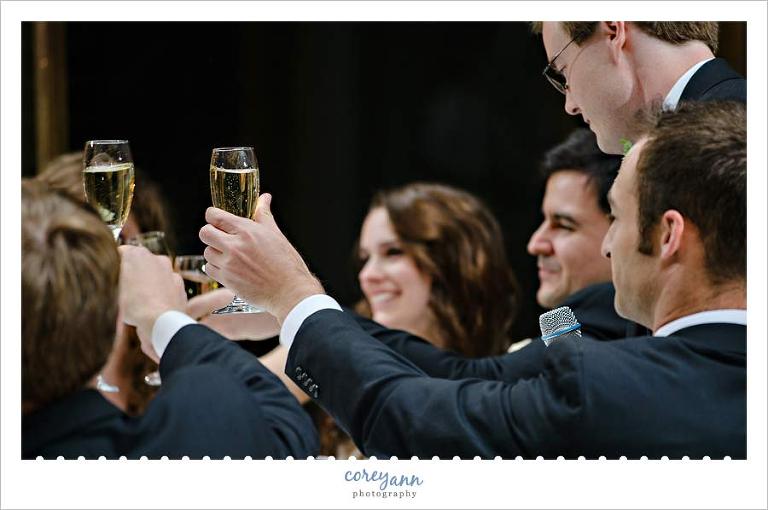 Wedding Party raising their champagne glasses in toast to the couple