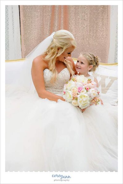 Bride and flower girl on couch