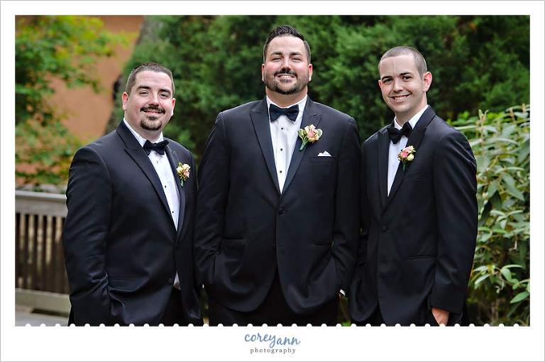 Groom and Groomsman in black tuxes with bowties