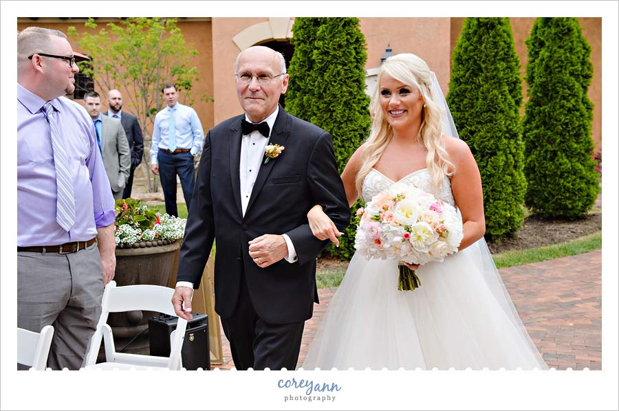 Bride walking down the aisle at outdoor ceremony
