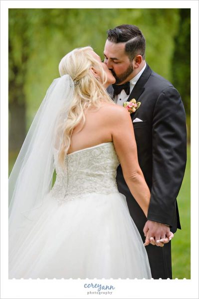 Bride and groom kissing after wedding ceremony