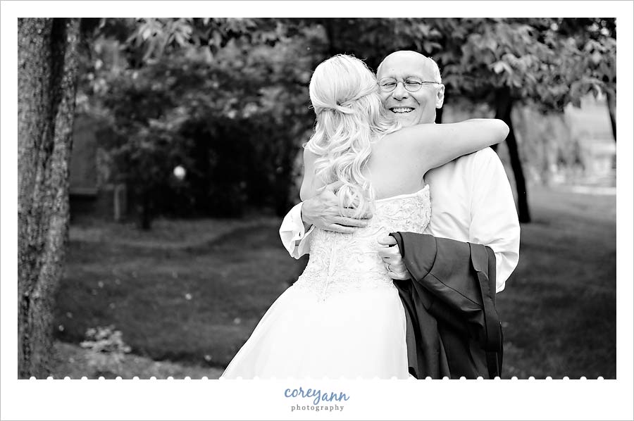Bride hugging her father after first look