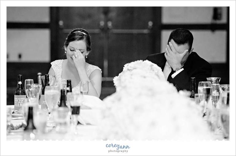 Bride and groom laughing during toasts at wedding reception in northeast ohio