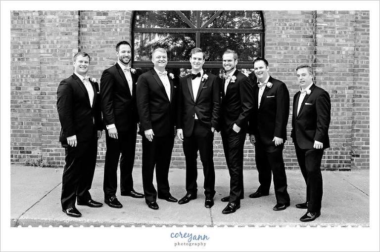 Groomsman in tuxes with black bow ties in Ohio