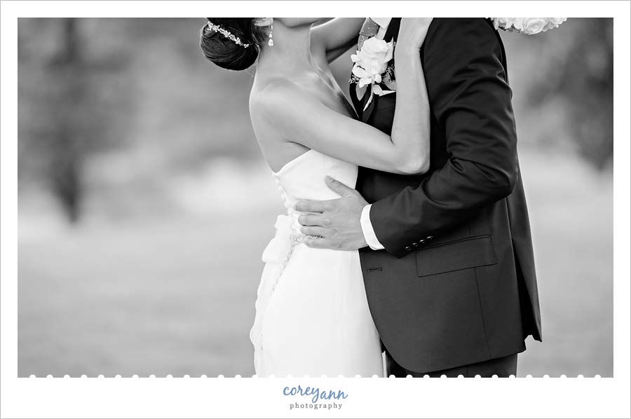 black and white wedding portrait of bride and groom kissing