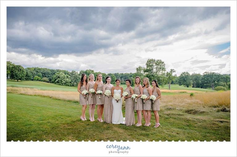 bride and bridesmaids beneath a stormy sky in ohio