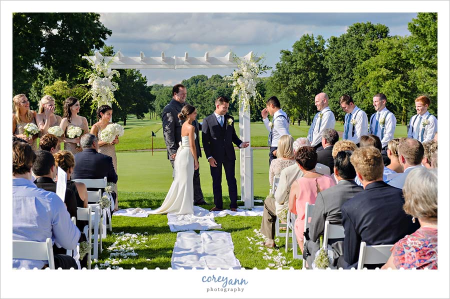 Groom getting ring from Best Man