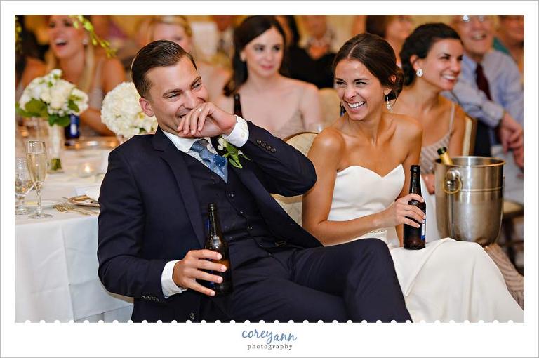 laughing during toasts at wedding reception