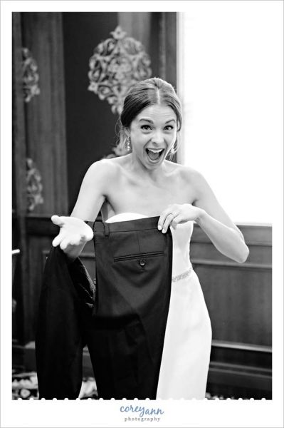 bride laughing while posing with ripped pants