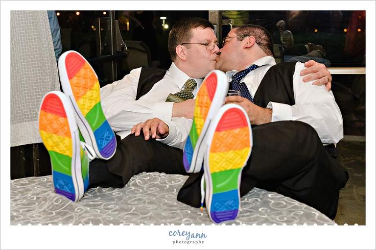 Wedding shoes showing off rainbow soles on table