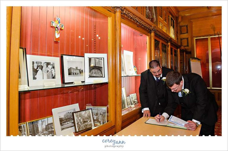 Grooms signing book for wedding ceremony 