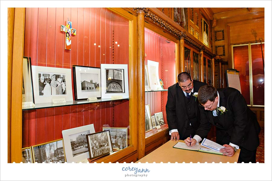 Grooms signing book for wedding ceremony