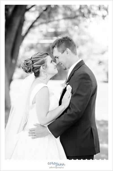Bride and groom nose to nose in black and white