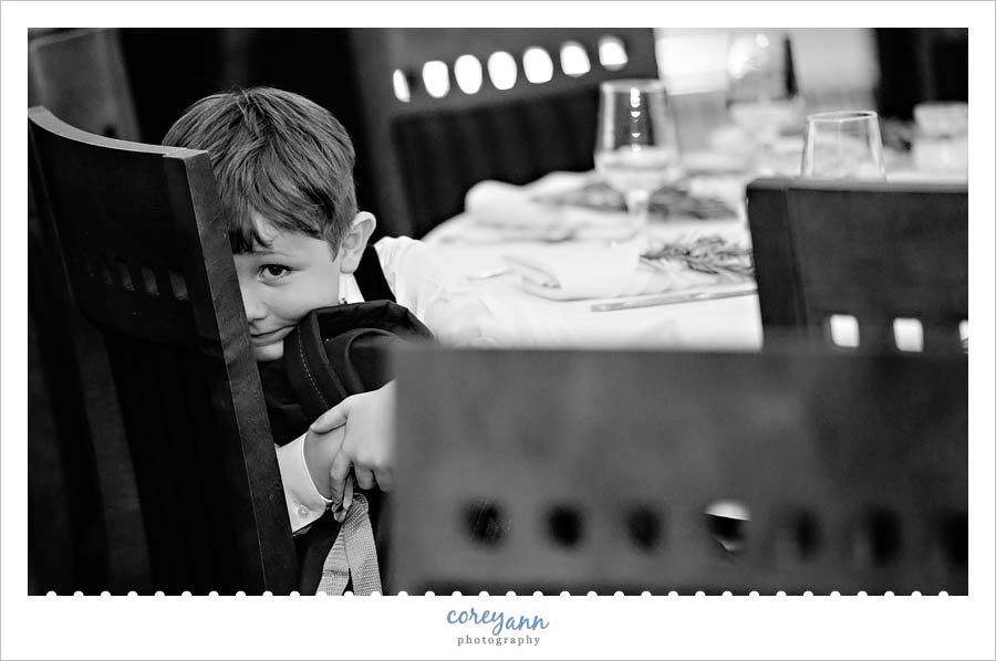 child hiding at wedding reception