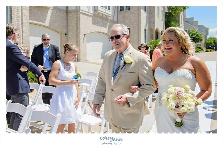 Bride and Father walking down aisle for outdoor wedding ceremony