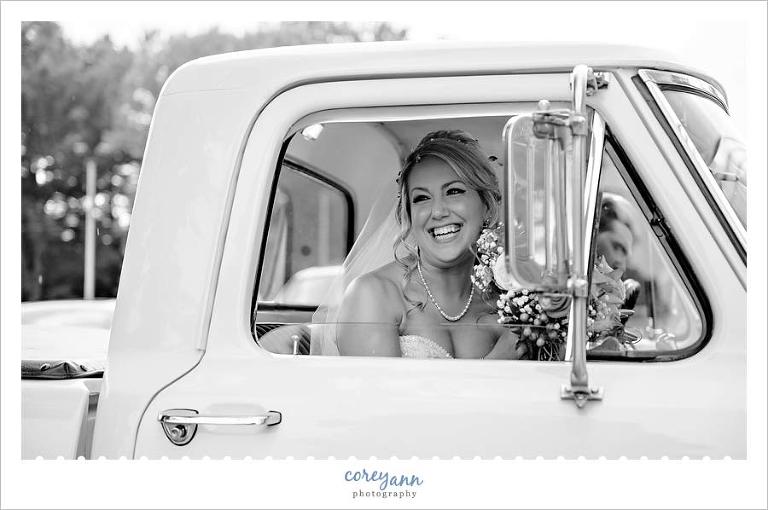 Bride in farm truck getaway vehicle for wedding