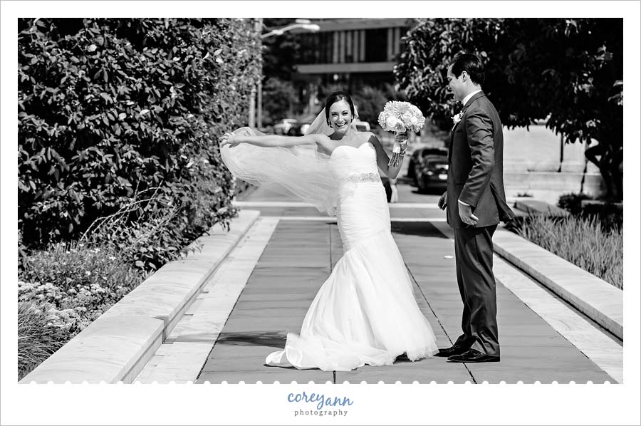 Bride laughing after veil blows away