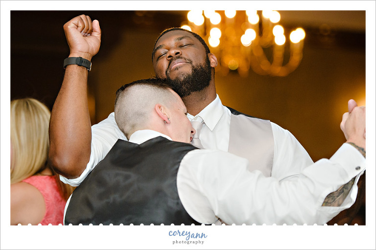 Groomsman dancing together at wedding reception in akron ohio