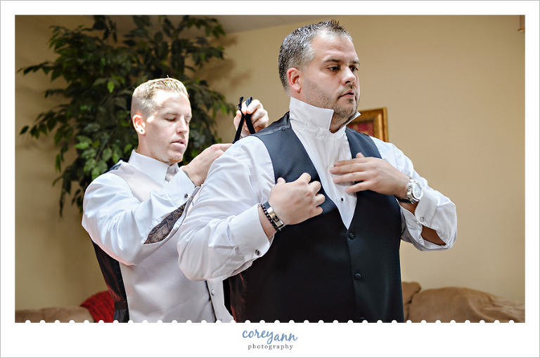 groom and groomsman getting ready for ceremony