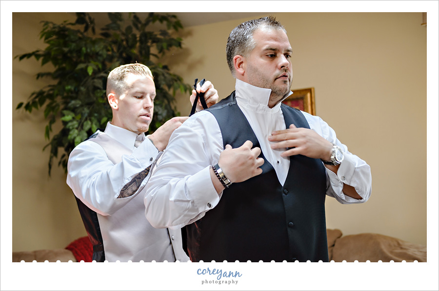groom and groomsman getting ready for ceremony