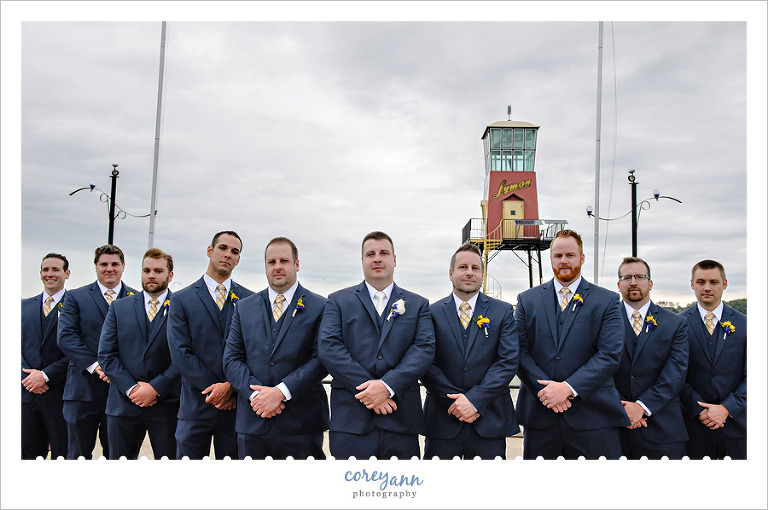 Groom and groomsman in front of Lyman Harbor Lighthouse