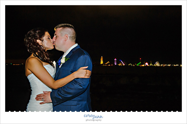 Bride and Groom kissing with Cedar Point skyline