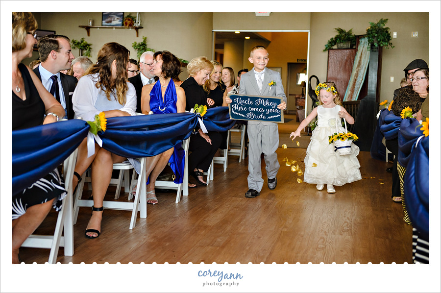 ring bearer and flower girl walking down aisle