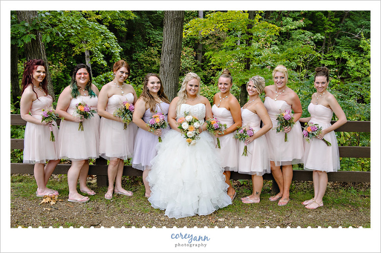 Bride and bridesmaids in pink and purple dresses