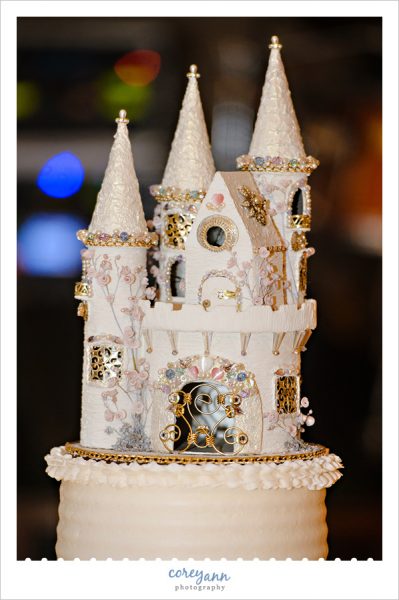 homemade castle cake topper on wedding cake