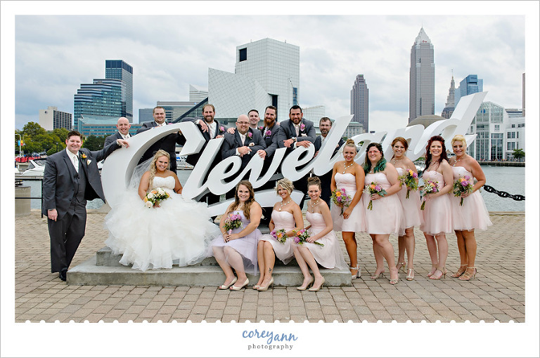 bridal party posing at the Cleveland sign downtown