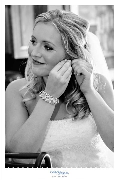 Bride putting in earrings 