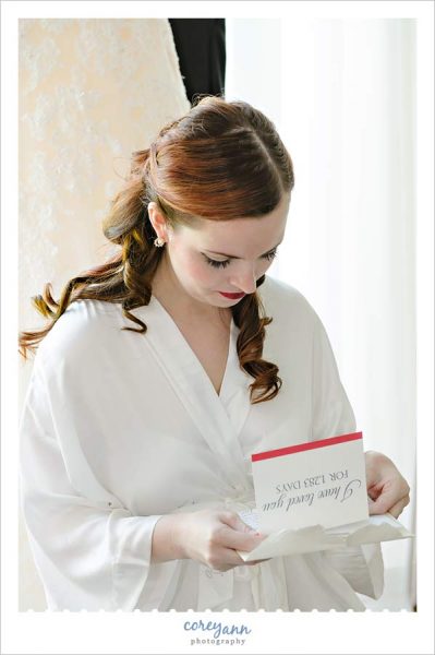 bride reading letter from groom before wedding