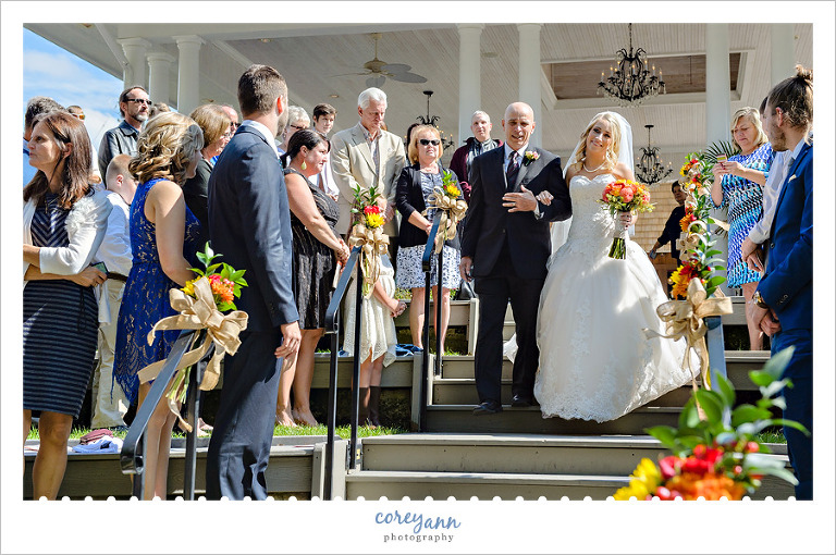 bride and father walking down stairs at grand pacific gardens