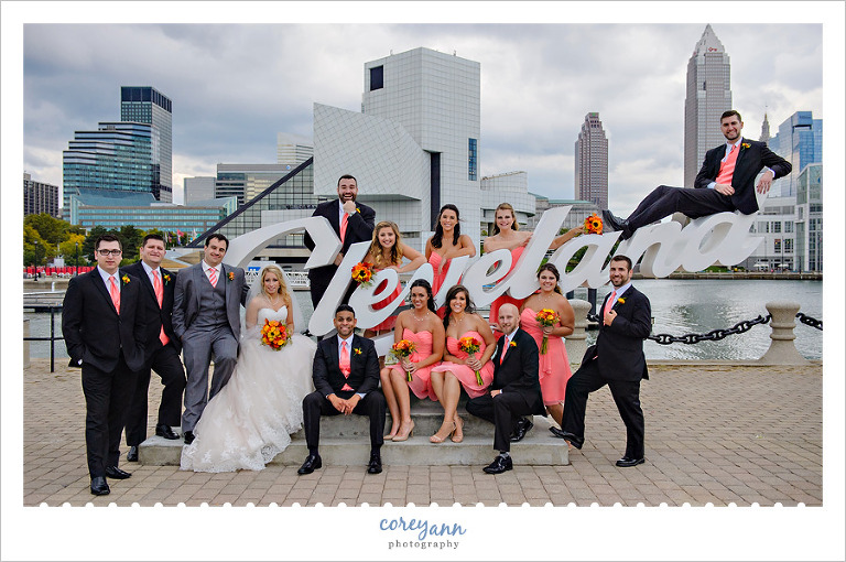 coral wedding party posing in downtown cleveland