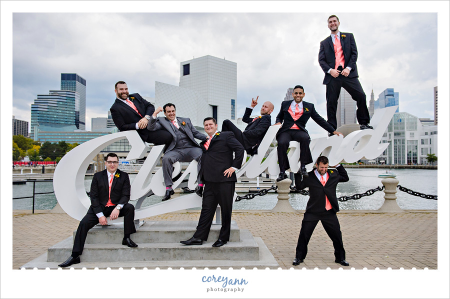 groomsman posing on the cleveland script sign in downtown cleveland