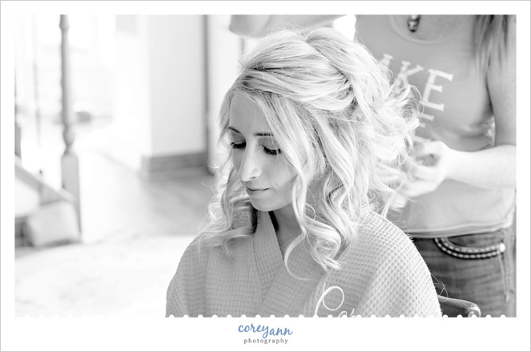 Bride getting her hair done before wedding