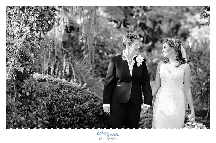 Brides walking hand and hand in the gardens