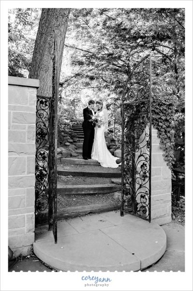 brides posing near gates inside cleveland botanical garden