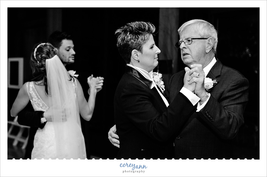 brides dancing with parents at wedding reception